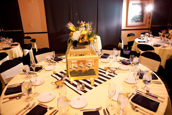 Reception table setting - Yellow tablecloth with black napkins and ...